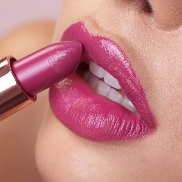pink lipstick being applied on lips