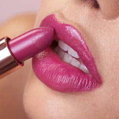 pink lipstick being applied on lips