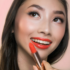 08 Coral Dawn - Natural Lipstick on a smiling model