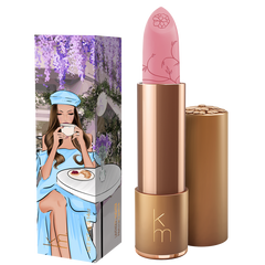 Pink Lipstick with pink cap and bronze body next to its packaging featuring an illustration of a woman.