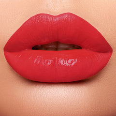 lips wearing all natural red shimmer lipstick