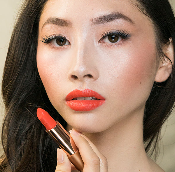 Model wearing Coral Dawn shade moisturising  natural lipstick