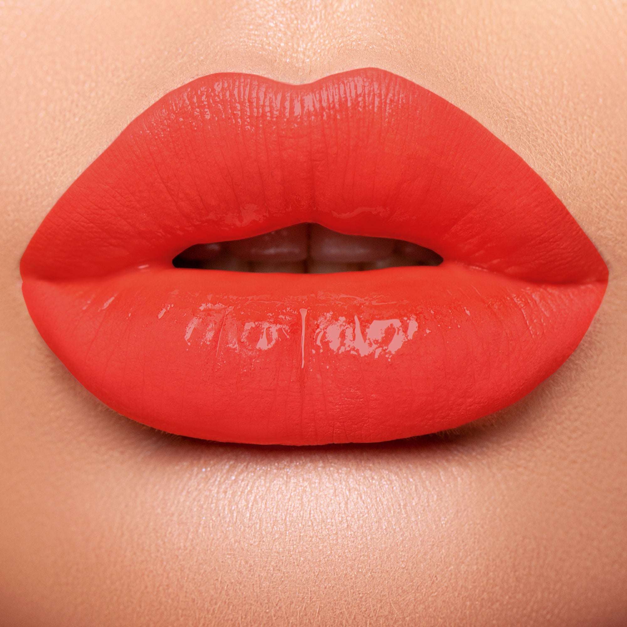 Lips wearing bright orange based red 