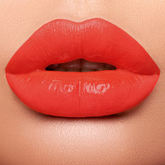 Lips wearing bright orange based red 